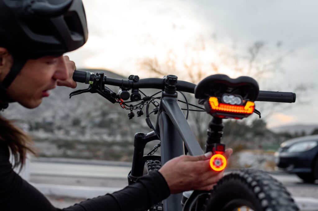 photo of person checking their rear bike light.
